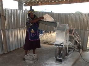 Naomi Gatsheni next to her grinding mill