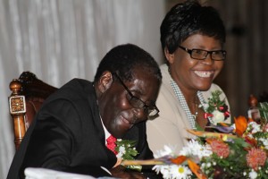 Living on a prayer ... President Robert Mugabe with Minister Miriam Chikukwa