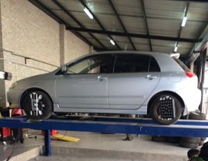 A vehicle undergoing a wheel alignment service