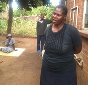 Mrs Gladys Cleopas with two of her mentally challenged children on the background (far right).