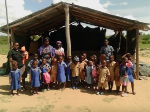 Tafara ECD pupils and teachers posing for a picture at their classroom structure