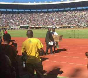 Patson Dzamara being whisked away by a state agent.