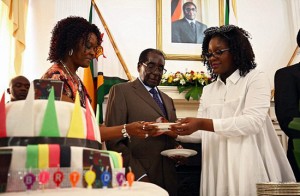 A heavily pregnant Bona (right) at President Mugabe's birthday party in February