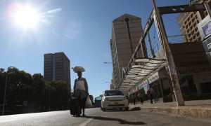 A woman walks along an empty street in the central business district of Harare during the shutdown on 6 July. Photograph: Philimon Bulawayo/Reuters