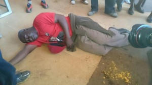 MDC-T man lays on the ground, beaten by 'police'