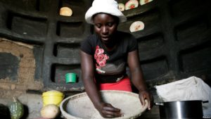 A woman prepares sorghum for food at her home in drought-hit Masvingo, Zimbabwe, June 1,2016.