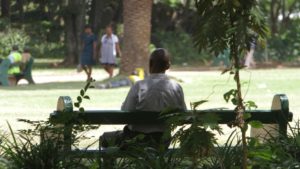 A man sits on a bench in a park in Harare, Zimbabwe, March 26, 2014. Zimbabwe has taken a new approach to addressing mental health issues by installing 'friendship benches' for counseling sessions.